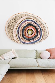 a living room with a couch and rug on the wall