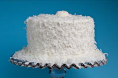 a white cake sitting on top of a glass plate