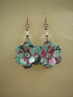 the earrings are decorated with flowers and glass bead details on hooks, along with earwires