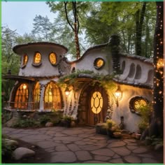 a fairy house with lights on the outside and windows that look like they are made out of stone