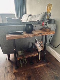 a living room with a couch, coffee table and other items on the floor in front of it