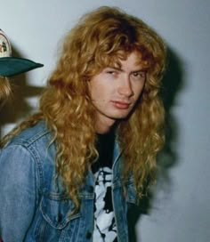 two young men with long hair wearing hats