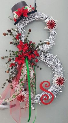 a white wreath with red flowers and a top hat hanging on the wall next to a sign that says 8