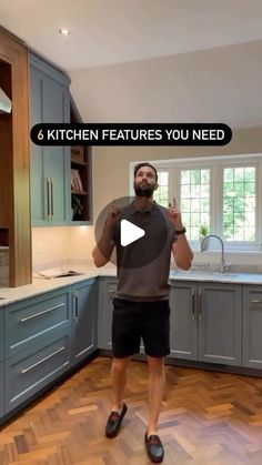 a man standing in the middle of a kitchen with his hands on his hips and text that reads 6 kitchen features you need