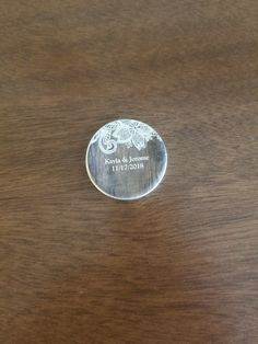 a close up of a wooden table with a coin on it