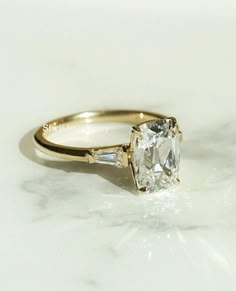 a close up of a diamond ring on a table