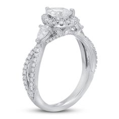 a white gold engagement ring with an oval center stone and side stones on the sides