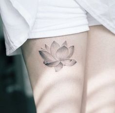 a woman's leg with a tattoo on it that has a flower in the middle