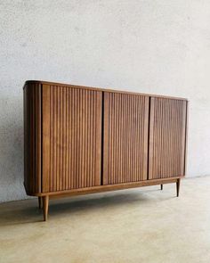 the sideboard is made out of wood and has vertical slats on it's sides