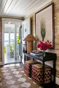 a room with a piano and flowers on the table