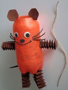 a paper mache rat made to look like a carrot with two ears and tail