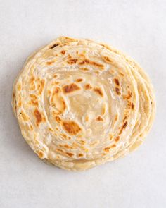 four flat breads stacked on top of each other in the middle of a circle