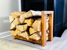 a pile of wood sitting in front of a fireplace