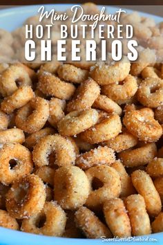 mini doughnuts in a blue bowl with the words hot buttered cheerios