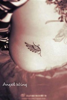 a woman's stomach with a small tattoo on the side of her belly and an angel wing