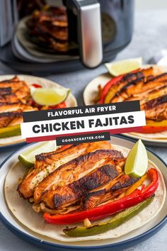 two plates filled with chicken fajitas on top of a table next to an air fryer