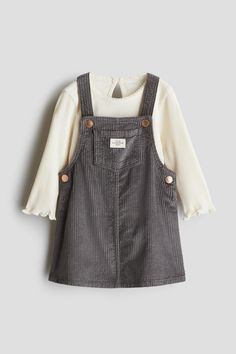 Set in cotton fabric with an overall dress and a ribbed top. Dress in soft corduroy with shoulder straps with snap fasteners  bib pocket  and snap fasteners at sides. Top in jersey with a round  picot-trimmed neckline  keyhole opening at back with a button  long sleeves  and overlocked trim at cuffs and hem. Gray And Cream Family Photos, Rich Kids Outfits, Cute Kid Clothes, Children Aesthetic, Childrens Fashion Trends, Baby Ray, Toddler Fits, Toddler Board, Vintage Kids Fashion