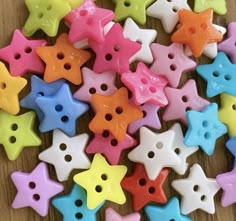 colorful star shaped buttons on a wooden surface