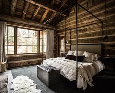 a bed sitting in a bedroom next to a window