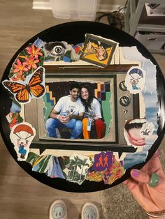 a person holding up a plate with pictures on it