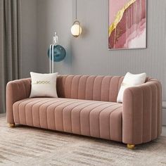 a living room scene with focus on the sofa and pillows, which are accented with wall art