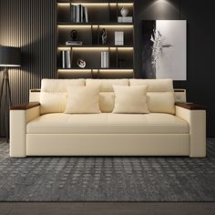 a white couch sitting in front of a book shelf