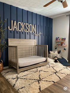 a baby's room with blue walls and wooden furniture