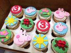 cupcakes with peppa the pig and other characters on them in a box