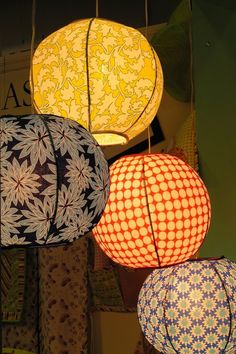 several paper lanterns are hanging from the ceiling