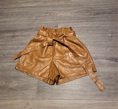 "Vtg chunky foxy brown vegan leather women`s shorts with elastic gum waist. With the tie belt. High waisted. Elastic Waist, Wide Leg, Front Real 2 sides pockets, side zipper, without textile lining, but inside soft textile. condition: great, a little bit used or unused. 1 darker spot on the back bottom - photo No.8. measurements in lying flat: waist in larger position 36 cm / 14\" in (adjustable)  height 37,5 cm /  14.6\" in bottom leg width 32 cm / 12.5\" in size: 46 (Italy), Estimated size is Chic High-waisted Shorts With Belt, Trendy Belted Shorts For Spring, Trendy High Waist Belted Shorts, Trendy High-waist Belted Shorts, Spring High-waisted Shorts With Belt, Chic High Waist Brown Shorts, Summer Brown Faux Leather Bottoms, Brown High-waisted Shorts With Belt Loops, Brown Faux Leather Shorts For Spring