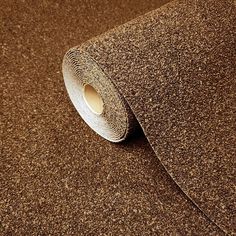 a roll of brown glitter paper on top of a table