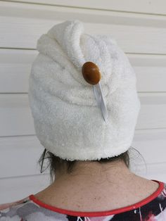 a woman with a white towel on her head has a knife stuck in the top of it