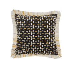 a black and yellow pillow with fringes on the front, sitting against a white background