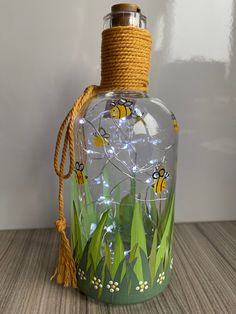 a glass bottle with some yellow and black bees on it