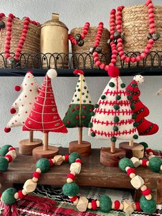 some christmas trees are on display in a room with baskets and other decorations around them