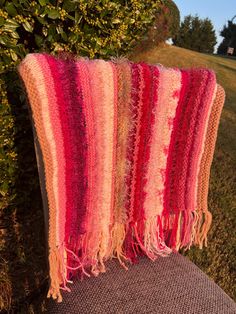 A beautiful hand knit shawl- "Pinks". Soft yarn, creating a one of a kind special piece. In knitting this prayer shawl, the original pattern was used; which is based on the "significance of three." That list is long, and at the top is "The Trinity" (Father, Son, and the Holy Ghost)... which is indicated by the three buttons on the shawl. This may be given as a prayer shawl, wrapping someone in warmth and prayers. When my grandmother knits prayer shawls, she prays while she is knitting hoping to bring comfort to a loved one.  The color combination creates a lovely combination of all the pinks you can imagine, from baby pink to a bold raspberry. To top it off, multi-fibers yarn always makes for a fun combination. A beautiful and one of a kind shawl. Sure to brighten and warm up anyones day. Hand Knit Shawl, Prayer Shawl, Knit Shawl, The Trinity, My Grandmother, Holy Ghost, Father Son, A Prayer, Knitted Shawls