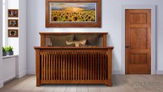 an empty room with sunflowers on the wall and a painting hanging above it