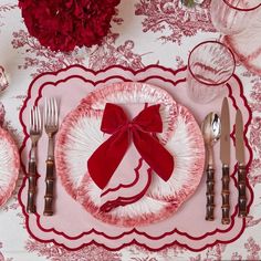 a red and white place setting on a table