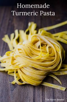 homemade turmeric pasta on a wooden table with text overlay that reads, homemade turmeric pasta