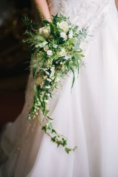 a woman in a wedding dress holding a bouquet