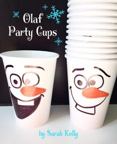 two cups with faces painted on them sitting next to each other