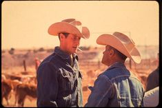 two men wearing cowboy hats standing next to each other