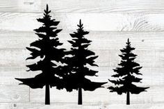 three silhouettes of trees against a white wood background