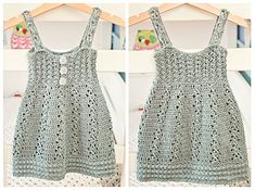 crocheted baby dress hanging on a clothes rack