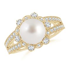 At the center of this charming pearl flower ring is a lustrous South Sea pearl. The prong set diamonds surrounding the cultured pearl create a brilliant floral halo while the pavé set diamonds on the split shank lend added glamour to the ring. Intricate milgrain detailing along the edges make this a truly exquisite pearl split shank ring in 14K yellow gold. Pearl Halo Ring, Pearl Flower Ring, Cultured Pearl Ring, Floral Halo, Split Shank Ring, Pearl And Diamond Ring, June Birthstone Jewelry, Split Shank, Halo Diamond Ring