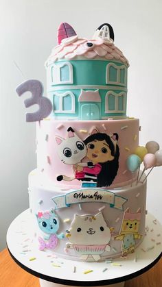 a three tiered cake with cartoon characters on it