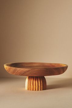 a wooden bowl sitting on top of a table