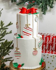 a three tiered cake decorated with christmas decorations