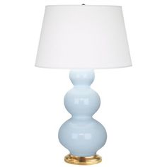 a light blue lamp with a white shade on it's side and a gold base