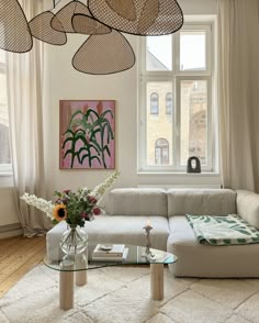 a living room filled with furniture next to a window covered in lots of light curtains